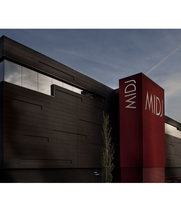 A modern building with a sleek black facade and a prominent red section displaying the word "MIDJ."