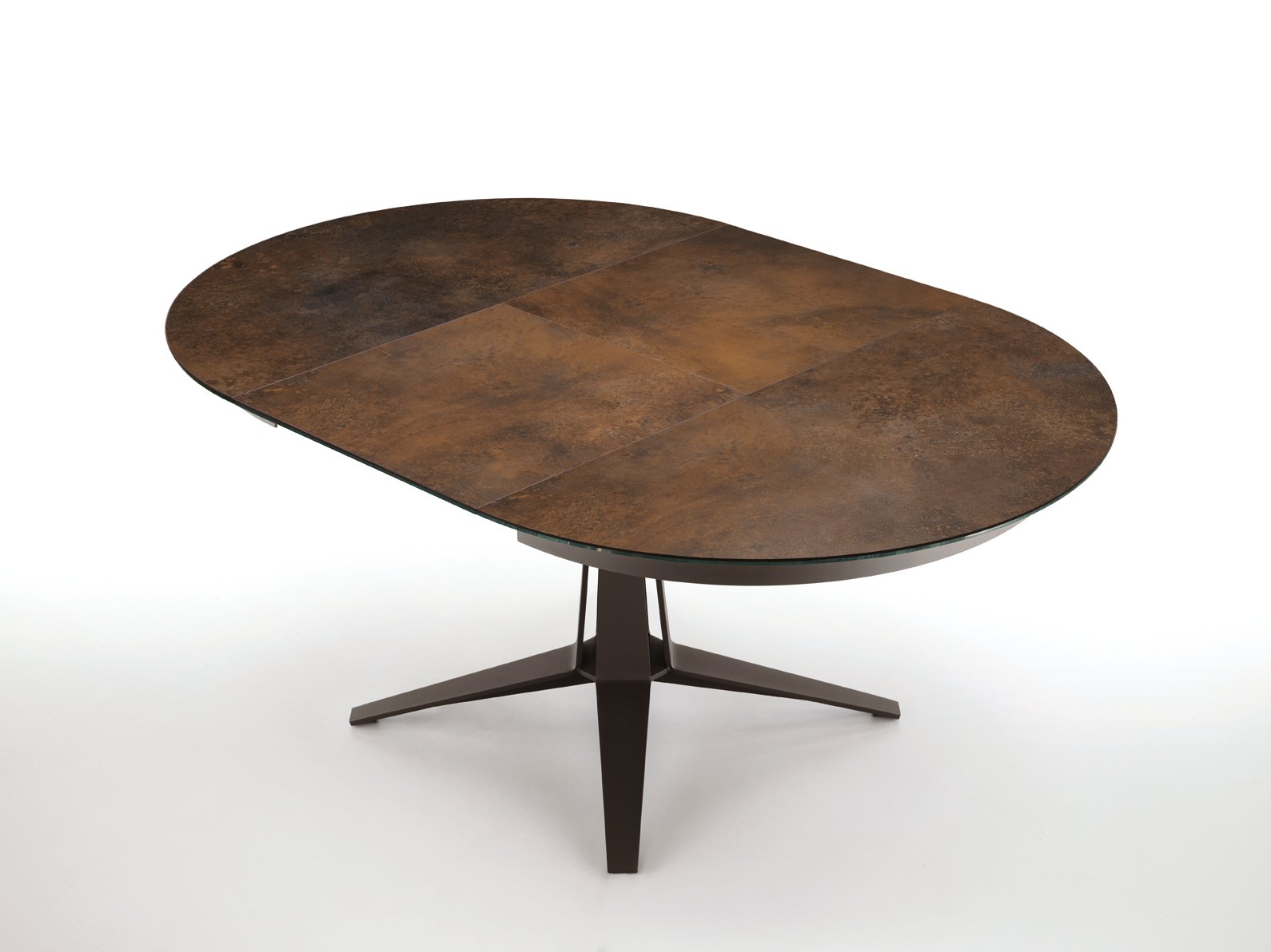 An oval dining table with a textured brown surface and a sleek black base, featuring a modern design.