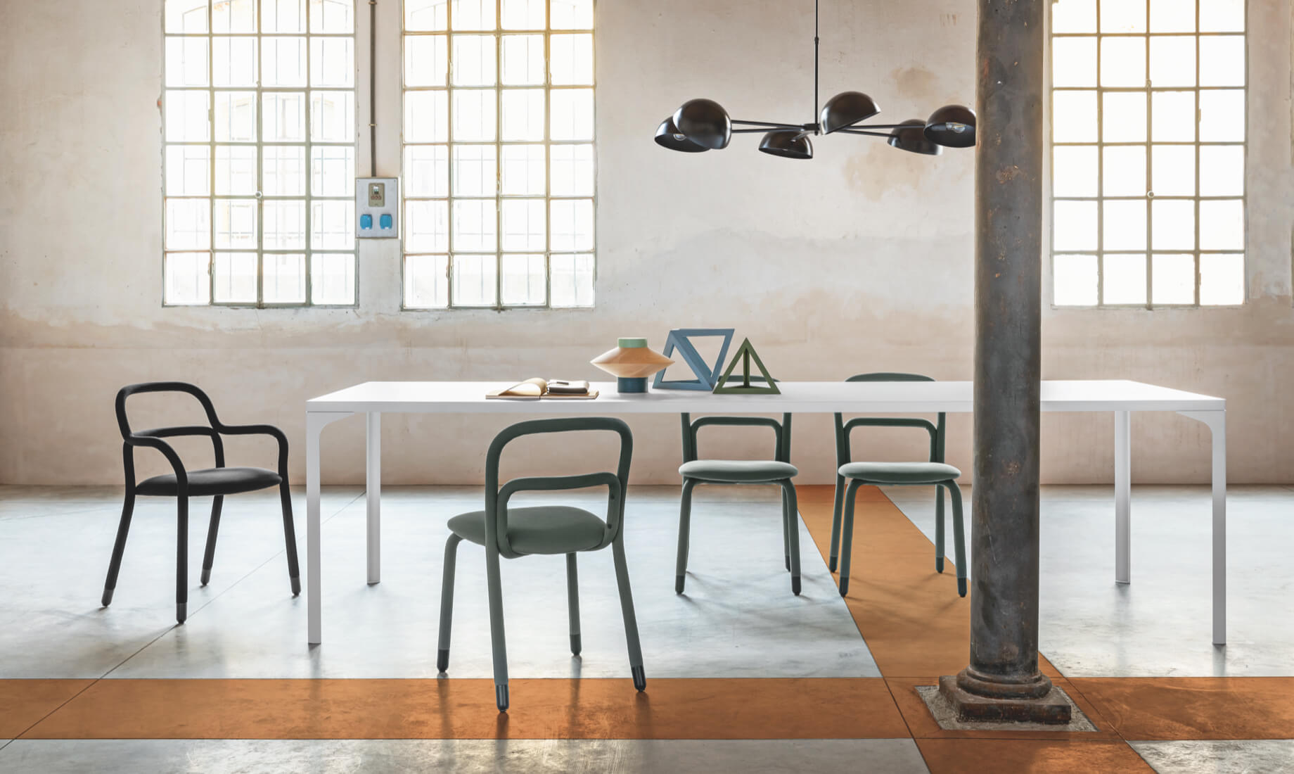 Pippi chair and armchair, design Roberto Paoli. Armando table, design Balutto Associati.