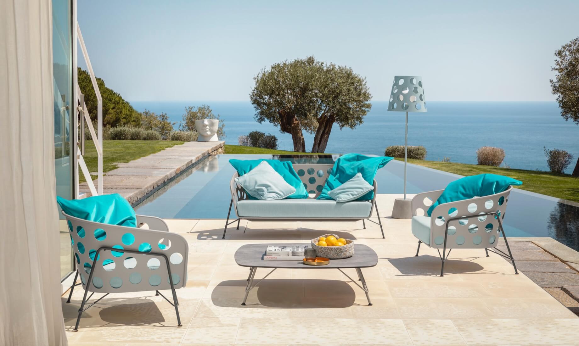 Armchair, sofa, floor lamp, and coffee table from the Bolle collection, design Paola Navone.