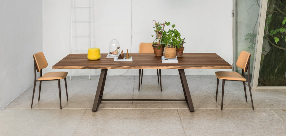 Alfred table with brown metal legs and solid walnut top with natural bark border