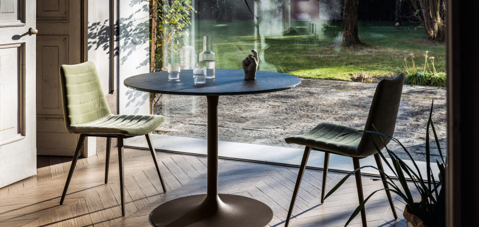 Cover chair with brown metal legs and seat upholstered in green fabric