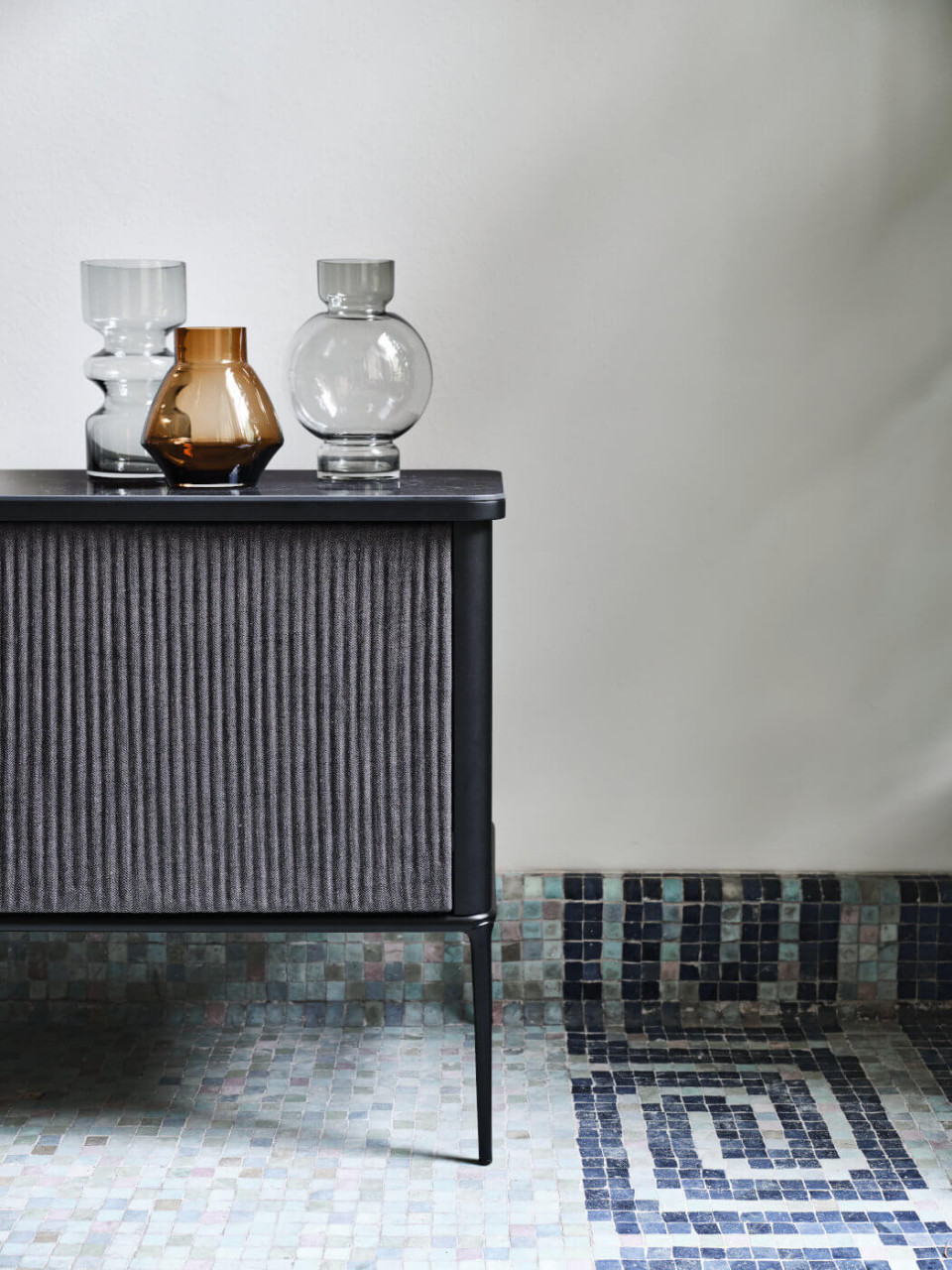 Detail of the doors covered with black fabric of the Lea sideboard
