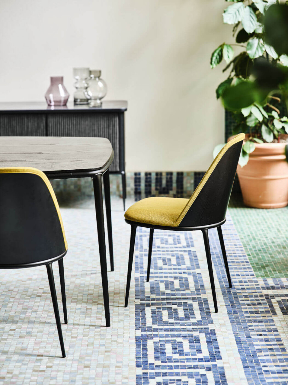 Lea chair with green upholstery and wooden back face