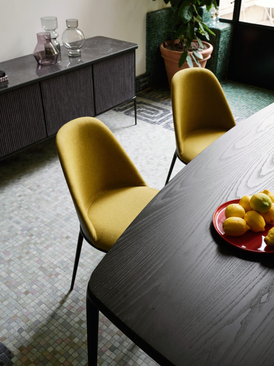 Lea chair with green upholstery and wooden back face