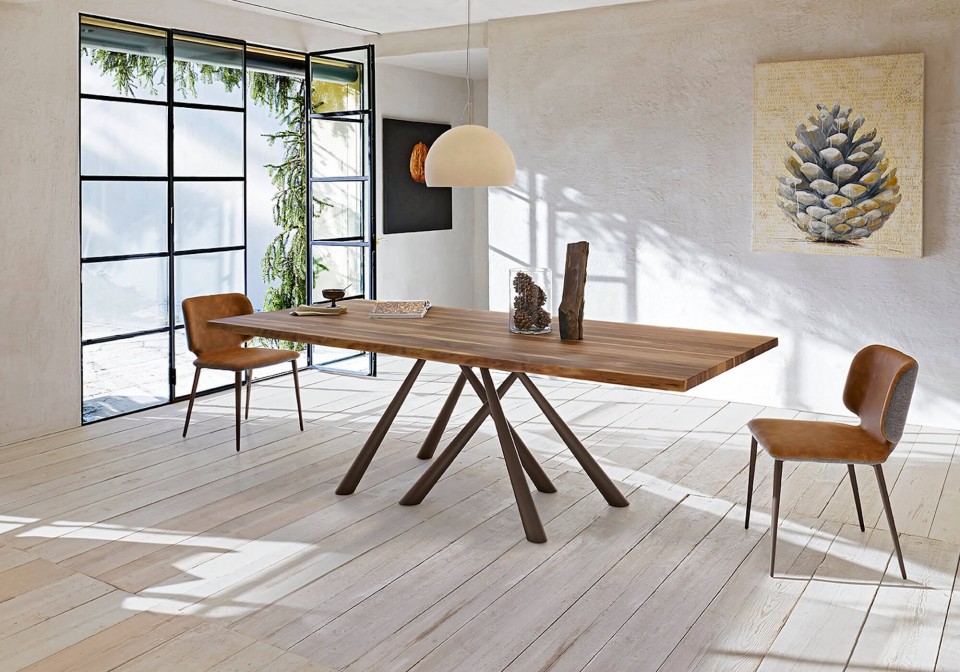 Forest table with brown metal base and solid walnut top with bark effect edge