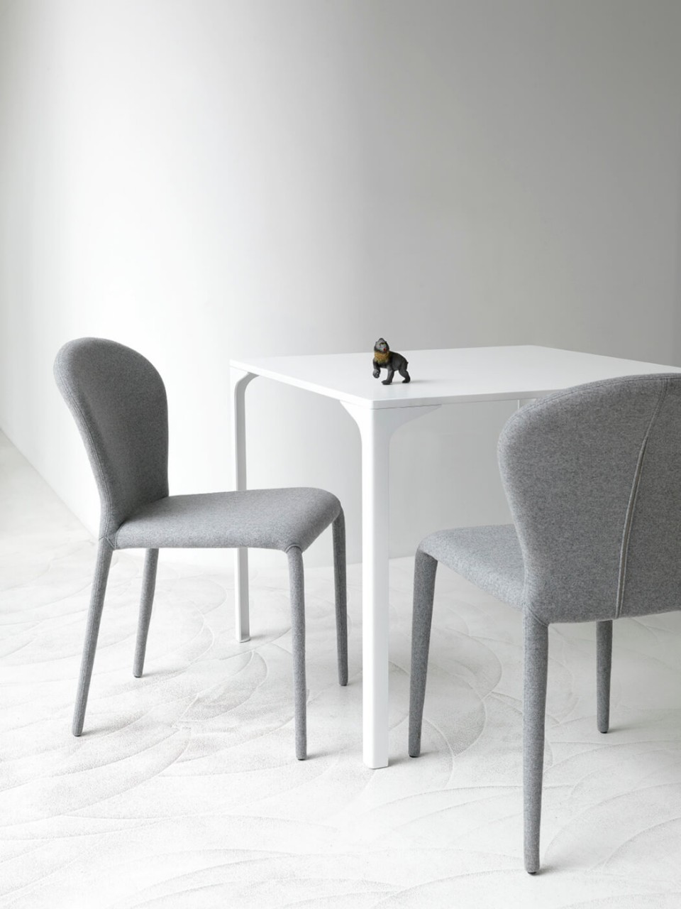 Soffio chair entirely covered in gray fabric